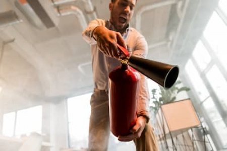 handsome-businessman-holding-extinguisher-and-yell-2024-11-17-18-29-40-utc (1).jpg